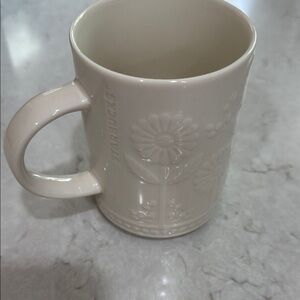 12 oz Starbucks coffee mug with an embossed floral sunflower design